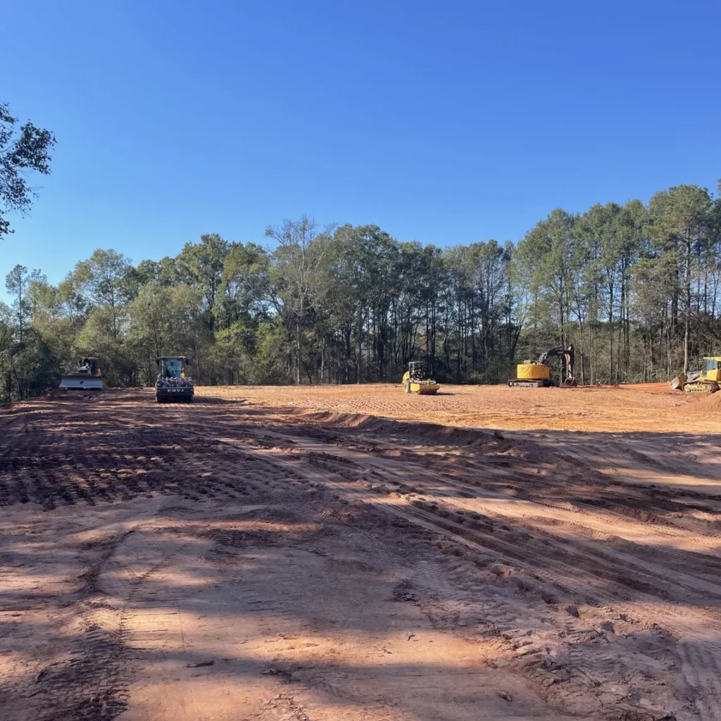 A Bray Siteworks heavy equipment operator performing high-capacity earthmoving and precise land clearing for a commercial project in Watkinsville, GA.